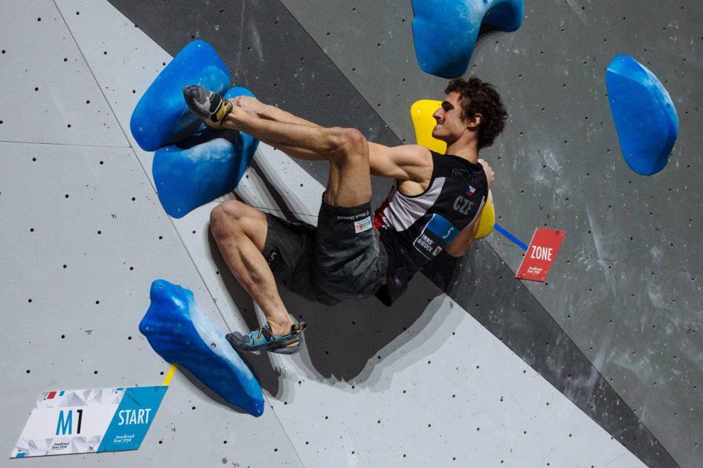 Adam Ondra climbing at a bouldering competition